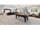 Spacious finished basement including a pool table, lounge seating, and walkout patio at 13974 Nina Dr, Carmel, IN 46074