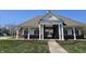 Exterior of a charming community clubhouse with brick accents, columns, and a landscaped walkway at 13974 Nina Dr, Carmel, IN 46074