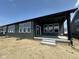 Contemporary home featuring a covered patio, multiple windows, and modern siding at 141 Creststone Blvd, Westfield, IN 46074