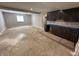 Basement with dark kitchen cabinets and space for an additional living area at 141 Creststone Blvd, Westfield, IN 46074