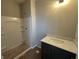 Bathroom with a single sink vanity and a shower with a white surround at 141 Creststone Blvd, Westfield, IN 46074