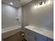 Bathroom featuring a tub with marble style tiling and vanity with modern lighting at 141 Creststone Blvd, Westfield, IN 46074