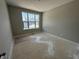 A bright bedroom is shown featuring a large window and neutral color scheme at 141 Creststone Blvd, Westfield, IN 46074
