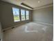Bedroom with a tray ceiling and large windows that let in natural light at 141 Creststone Blvd, Westfield, IN 46074