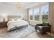 Serene bedroom with natural light, a cozy rug, decorative chandelier, and upholstered headboard at 141 Creststone Blvd, Westfield, IN 46074