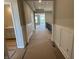 View of hallway with paneled walls leading to rooms with bright natural light at 141 Creststone Blvd, Westfield, IN 46074