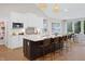 Sleek kitchen with white cabinets, a large island, barstool seating and modern appliances at 141 Creststone Blvd, Westfield, IN 46074