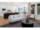Open-concept living space with a comfortable sofa and a view of the modern kitchen at 141 Creststone Blvd, Westfield, IN 46074