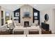 Elegant living room features a floor-to-ceiling stone fireplace and abundant natural light at 141 Creststone Blvd, Westfield, IN 46074