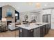 Open-concept living space showcases a stone fireplace, modern furnishings, and access to the kitchen at 141 Creststone Blvd, Westfield, IN 46074