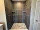 Modern tiled shower with built-in shelves and a hexagon tile floor at 141 Creststone Blvd, Westfield, IN 46074