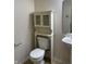 Bathroom featuring a white toilet with cabinet, tile floors, and a wall mirror at 14243 Clapboard Dr, Noblesville, IN 46060
