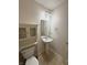 Bathroom featuring a white toilet, tile floors, a pedestal sink and a wall mirror at 14243 Clapboard Dr, Noblesville, IN 46060