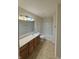 Well-lit bathroom featuring a single sink vanity, tiled floors, and a shower-tub combination at 14243 Clapboard Dr, Noblesville, IN 46060