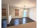 Inviting dining room with modern dark floors, a stylish chandelier, and ample natural light at 14243 Clapboard Dr, Noblesville, IN 46060
