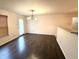 Cozy dining room with hard wood floors, a chandelier, and access to the kitchen at 14243 Clapboard Dr, Noblesville, IN 46060