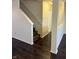 Hallway with hard wood floors and white walls leading to carpeted stairs at 14243 Clapboard Dr, Noblesville, IN 46060