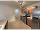 Kitchen with stainless steel appliances, wood cabinets, and tile flooring at 14243 Clapboard Dr, Noblesville, IN 46060