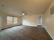 Spacious living room featuring carpet flooring, ceiling fan, and lots of natural light at 14243 Clapboard Dr, Noblesville, IN 46060
