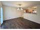 Open-concept living space with hardwood flooring, a view of the kitchen, and natural light at 14243 Clapboard Dr, Noblesville, IN 46060