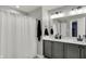 Modern bathroom with double vanity, updated fixtures, and shower with curtain at 146 Handley St, Indianapolis, IN 46222