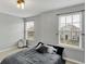 Sunlit bedroom with gray walls and a bed that has multiple pillows for extra comfort at 146 Handley St, Indianapolis, IN 46222