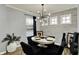 Dining area with wood flooring, modern lighting, and large windows at 146 Handley St, Indianapolis, IN 46222