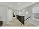 Bright hallway featuring neutral carpet, staircase and view of the bedroom at the end at 146 Handley St, Indianapolis, IN 46222