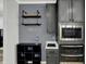 Modern kitchen design with stainless appliances, dark cabinetry, and open shelving for glassware at 146 Handley St, Indianapolis, IN 46222