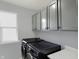 Modern laundry room with gray cabinets, black washer/dryer, and a white folding countertop at 146 Handley St, Indianapolis, IN 46222