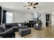 Cozy living room featuring a large sectional sofa, ceiling fan and staircase to upper level at 146 Handley St, Indianapolis, IN 46222