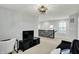 Bright open living room with modern light fixture and stylish black media center at 146 Handley St, Indianapolis, IN 46222