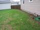 View of the grassy area along the side of the house, showcasing the landscaped yard and fencing at 150 E Carlisle St, Mooresville, IN 46158