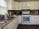 Well-lit kitchen features white cabinets, stainless steel sink, and modern appliances, providing functionality at 150 E Carlisle St, Mooresville, IN 46158