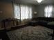 Comfortable living room with stylish gray sectional sofa and bright natural light at 150 E Carlisle St, Mooresville, IN 46158