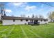 Spacious backyard with a deck and lush green grass at 1520 E 87Th St, Indianapolis, IN 46240