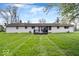 Wide backyard with a deck and healthy green grass at 1520 E 87Th St, Indianapolis, IN 46240