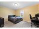 Bedroom featuring neutral walls, a bed with blue sheets, and a built-in desk at 1520 E 87Th St, Indianapolis, IN 46240