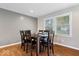 Dining room featuring hardwood floors, a modern light fixture, and natural light from backyard views at 1520 E 87Th St, Indianapolis, IN 46240