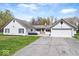 Charming single-story home with a white painted brick facade, attached garage, and well-maintained lawn at 1520 E 87Th St, Indianapolis, IN 46240
