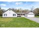 Charming single-story home with a white painted brick facade, attached garage, and well-maintained lawn at 1520 E 87Th St, Indianapolis, IN 46240