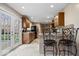 Stylish kitchen featuring updated countertops and bar seating, stainless steel appliances, and backyard access at 1520 E 87Th St, Indianapolis, IN 46240