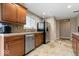 Traditional kitchen showcasing wood cabinets, stainless steel appliances, tile backsplash, and modern flooring at 1520 E 87Th St, Indianapolis, IN 46240