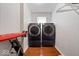 Compact laundry room with side-by-side washer and dryer and included ironing board at 1520 E 87Th St, Indianapolis, IN 46240