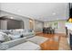 Spacious living room featuring hardwood floors, modern decor, and a dining area with a table and chairs at 1520 E 87Th St, Indianapolis, IN 46240