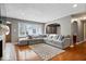Comfortable living room with a large sectional, hardwood floors, ample natural light, and neutral decor at 1520 E 87Th St, Indianapolis, IN 46240
