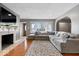 Comfortable living room with a large sectional, fireplace, hardwood floors, and ample natural light at 1520 E 87Th St, Indianapolis, IN 46240