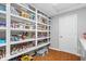 Walk-in pantry offering ample storage with shelving and wood flooring at 1520 E 87Th St, Indianapolis, IN 46240