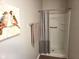 Bright bathroom with a white shower, gray walls, decorative bird art, and wood-look floors at 1615 Capra Ct, Beech Grove, IN 46107