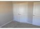 Bedroom closet featuring double doors and a smooth carpet at 1615 Capra Ct, Beech Grove, IN 46107